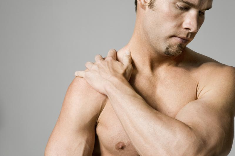 Man massaging shoulder